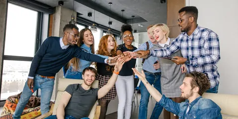 group of people joining hands